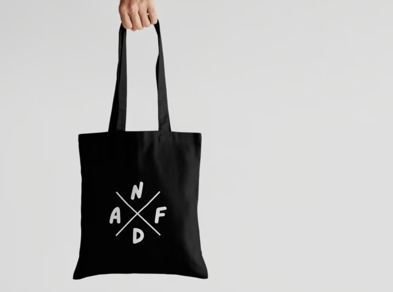 Black tote bag with a large "NDAF" logo.